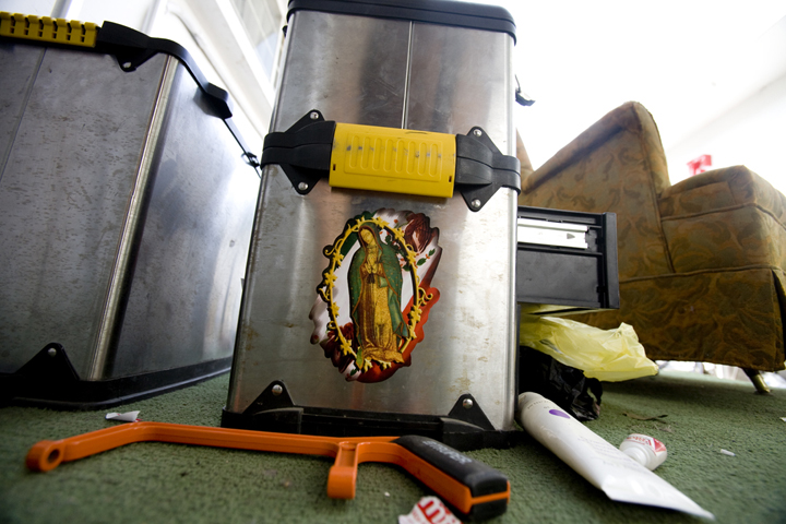 An engineer at a video studio in Monterrey, Mexico has placed a sticker of the Virgen de Guadalupe on his toolbox for protection, although the Mexican flag in the background also shows his patriotism.