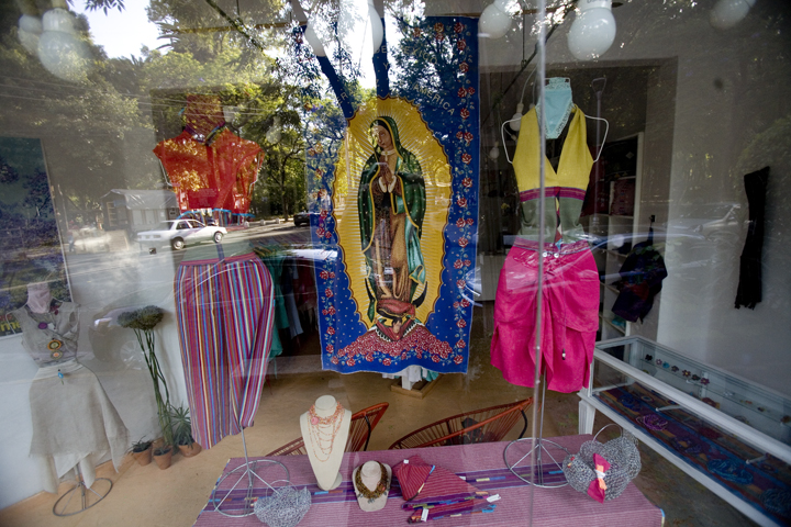 The Virgin of Guadalupe is placed inbetween clothes in a trendy boutique in the Condesa neighborhood in Mexico City.